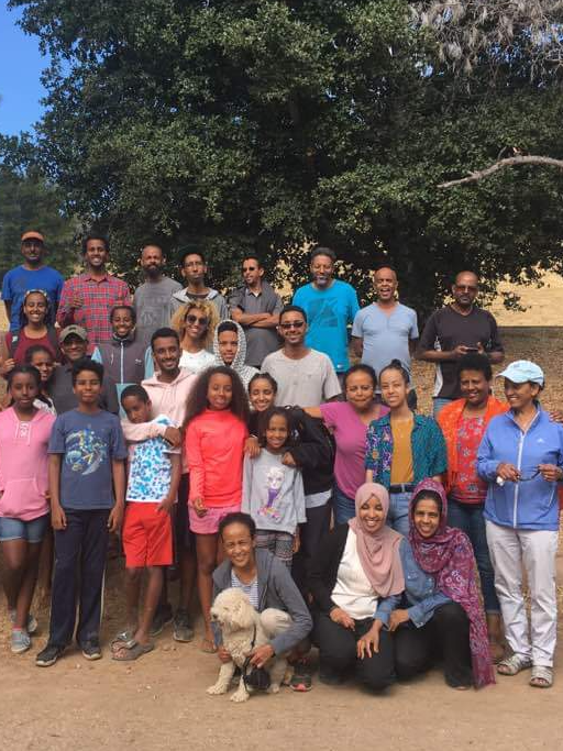 Large multigenerational community group gathered outdoors